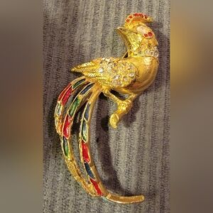 Vintage Rhinestone Brooch features a design of a bird of paradise or phoenix